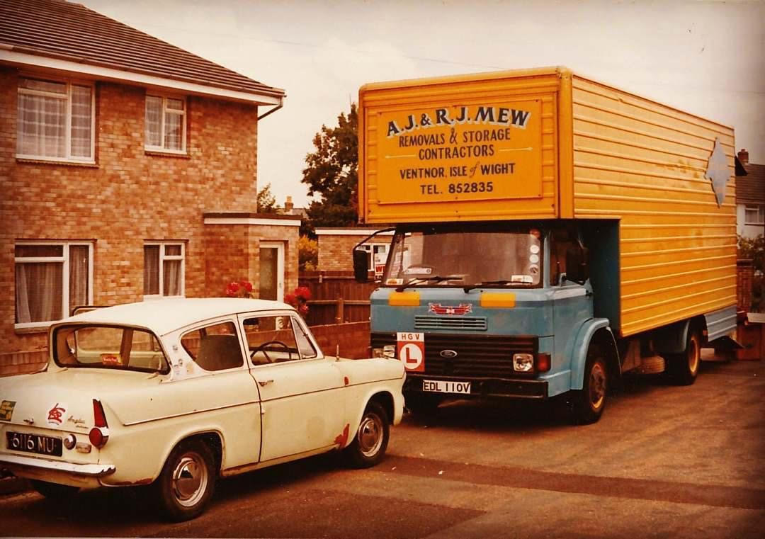 Vintage Mew family removal lorry parked outside a house